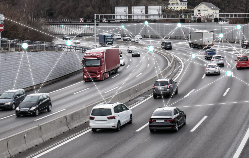 Illustration and photo of a autonomous self-driving cars driving on a highway. The cars are connected through wireless technology and artificial intelligence which enables them to drive on the road safely.